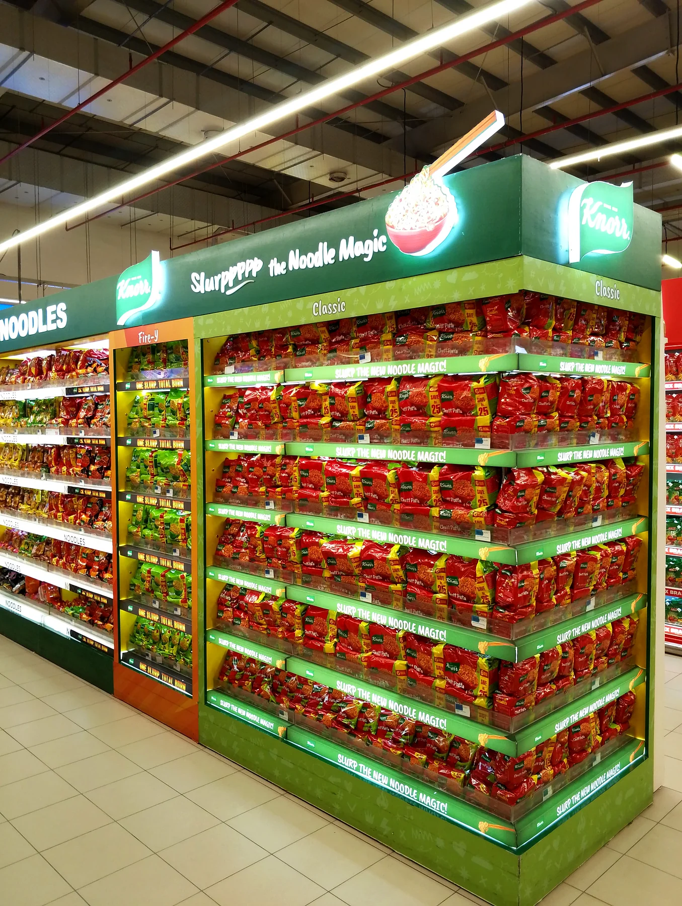 Illuminated Knorr noodle category run at a store corner