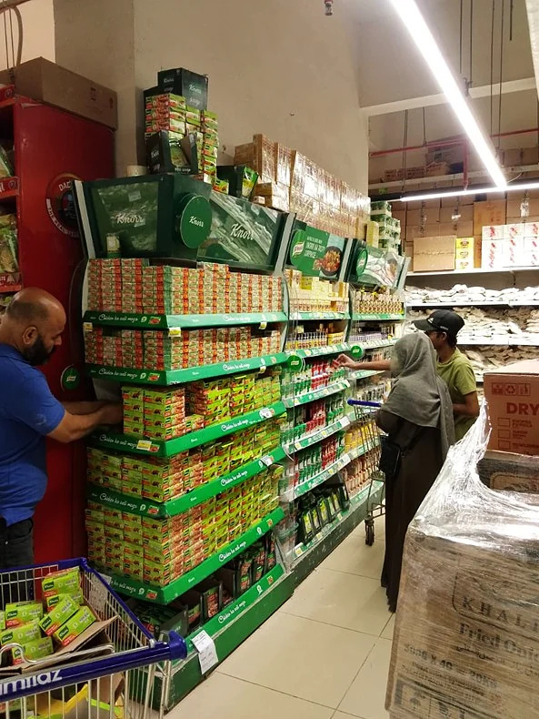 The Knorr category bay during installation, crew fitting the shelving