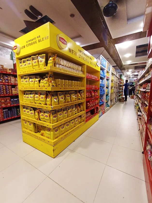 Yellow Knorr end-mode gondola in the Baig Mart aisle