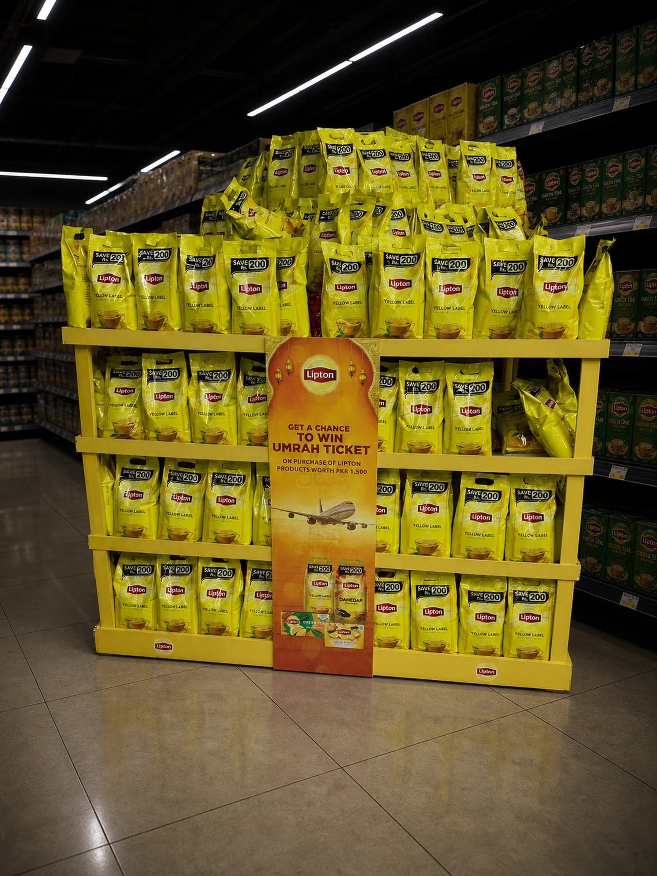 Stacked Lipton product podium with the Umrah campaign header at Emporium Mall