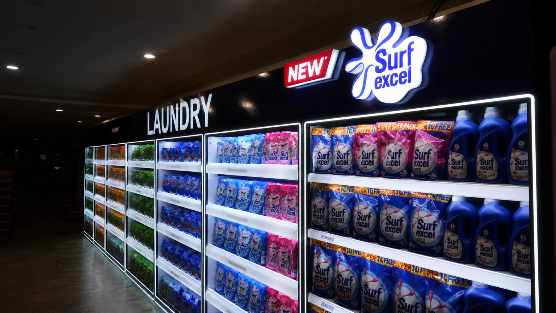 Finished illuminated Surf Excel laundry fascia above the category