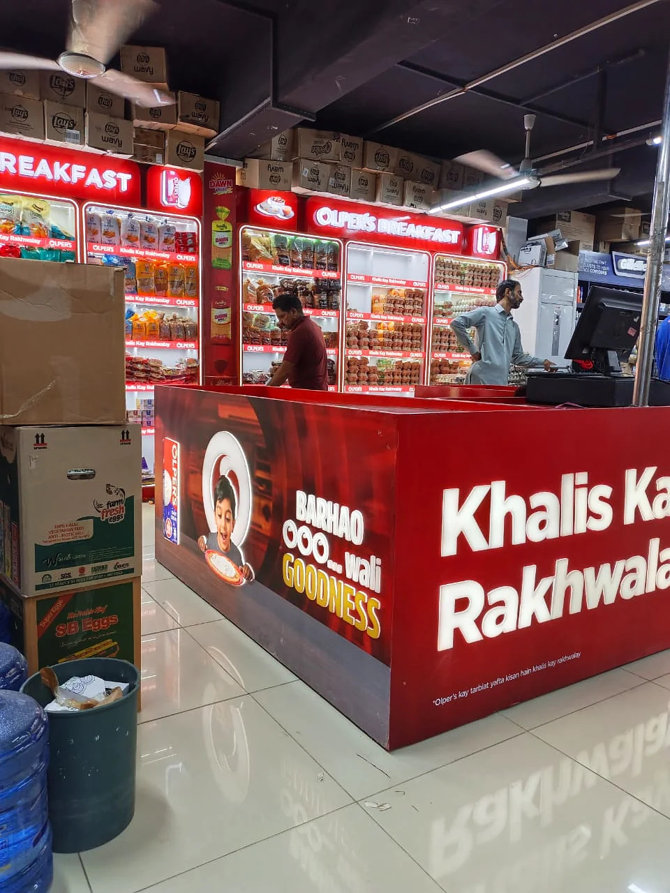 Olper's Breakfast illuminated chiller wall behind the checkout