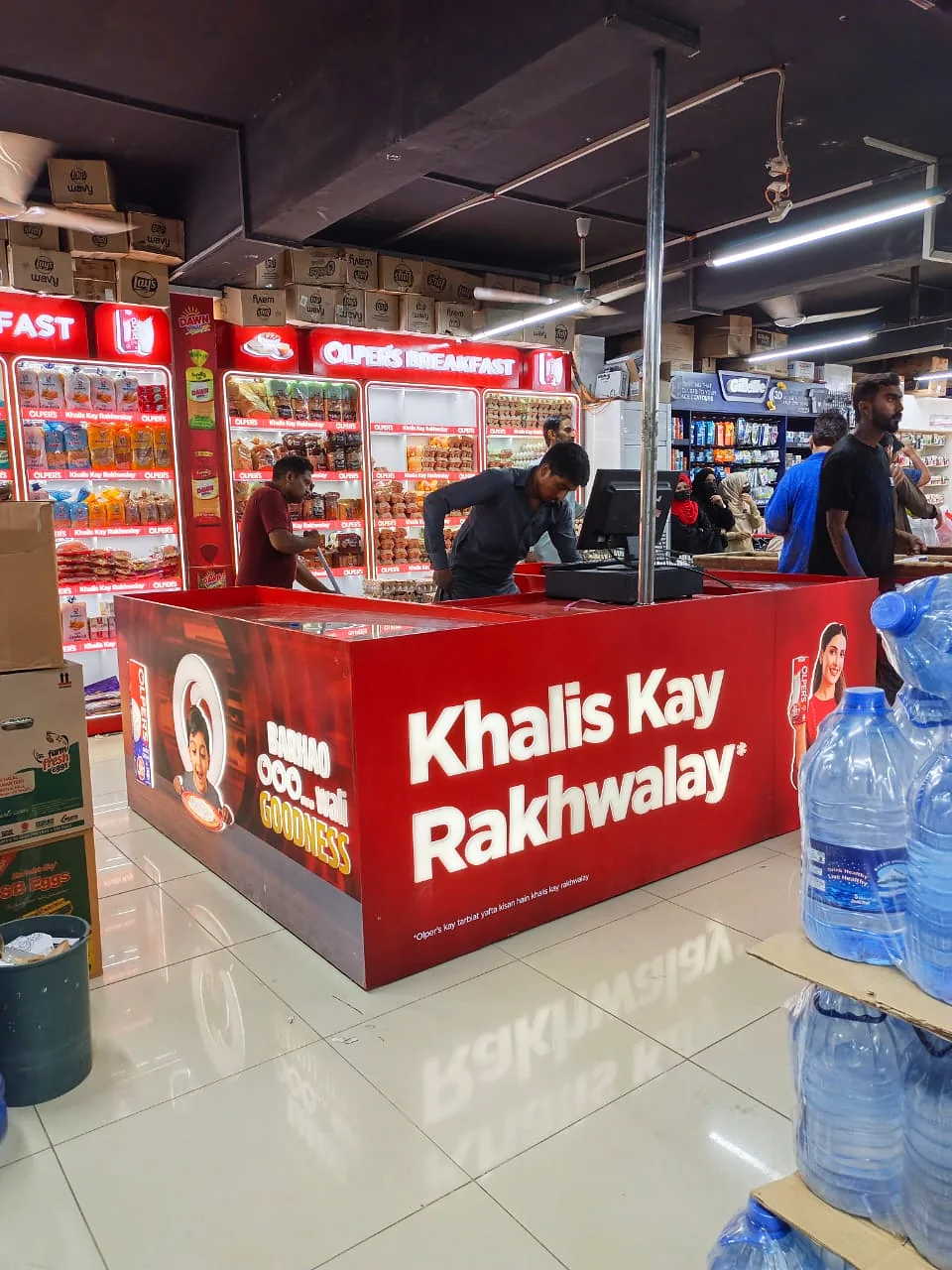 The Olper's checkout wrap in operation with staff at the till