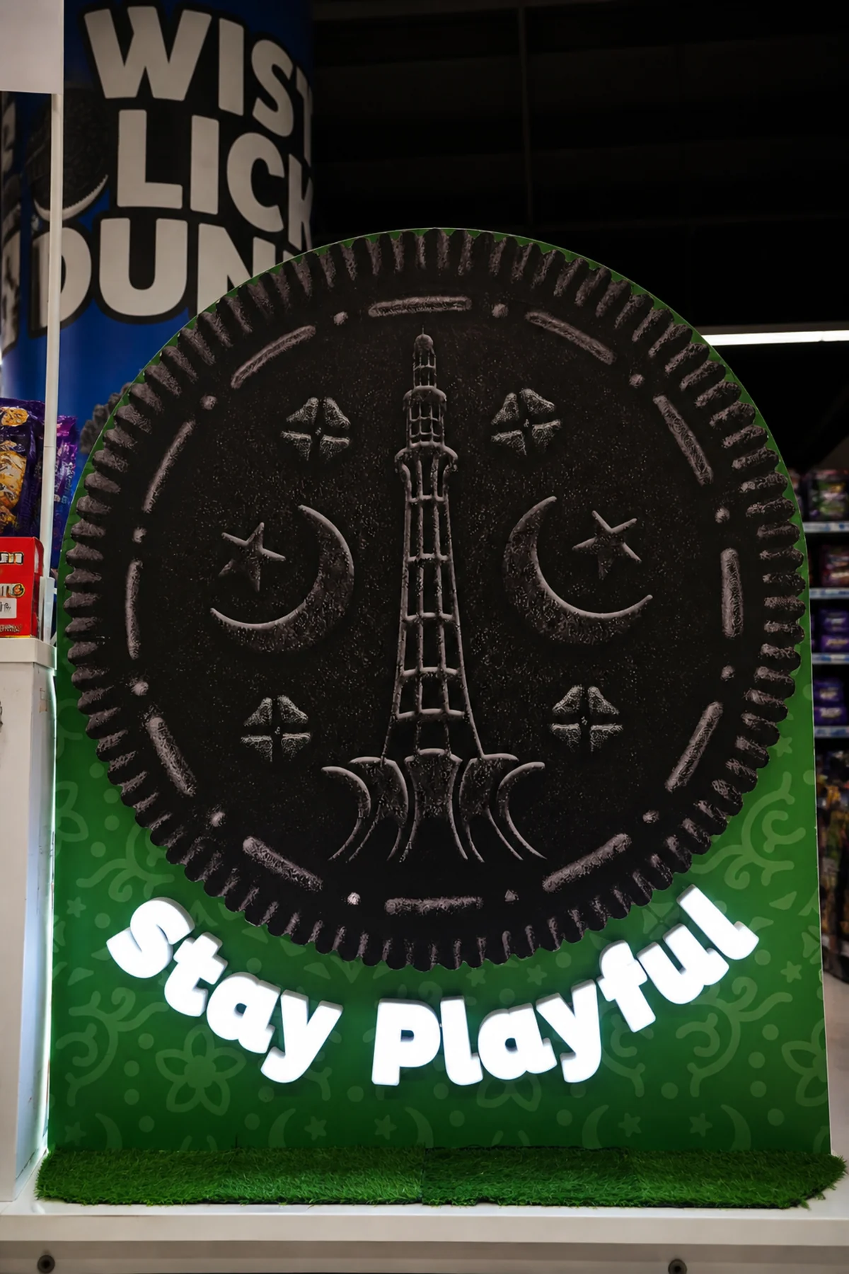 Close view of an embossed Stay Playful biscuit disc on the arch