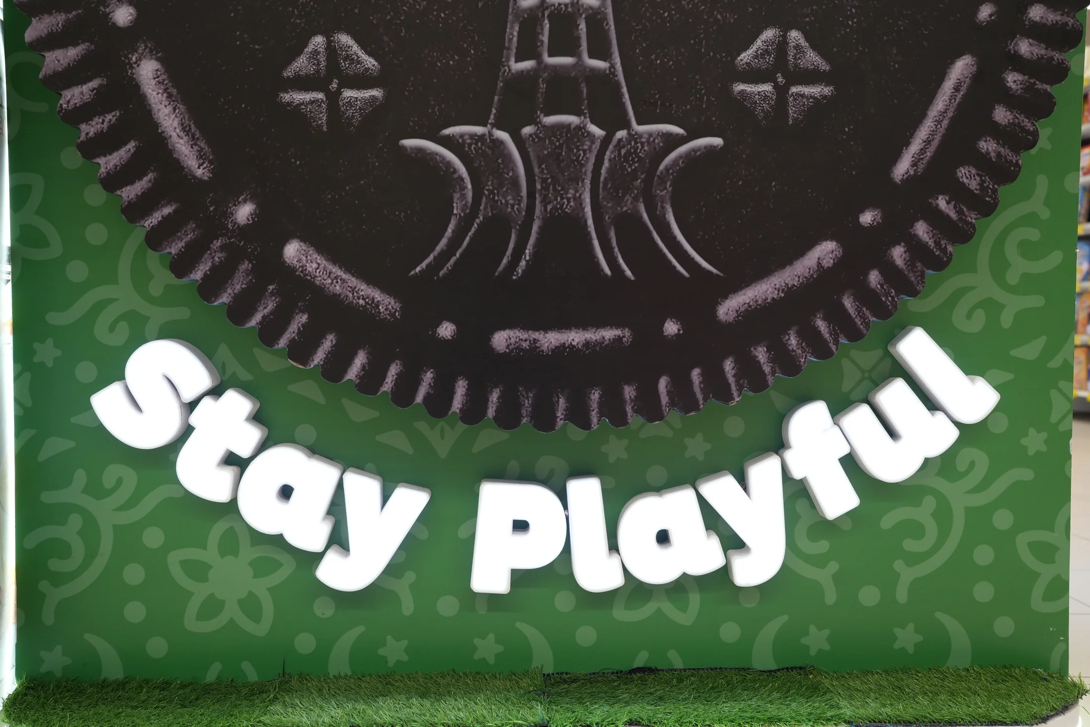 Close view of the landmark Oreo cookie and raised Stay Playful lettering